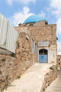 View of old building against cloudy sky