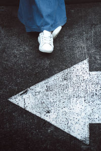 Low section of person standing on road