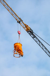 Low angle view of crane against sky