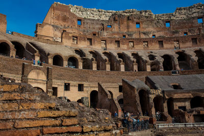 Tourists visiting the interior of the famous colosseum in rome