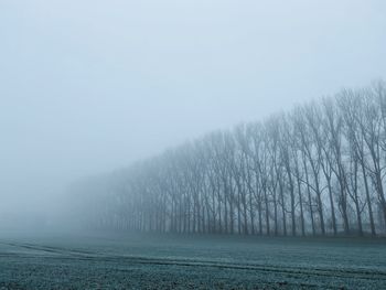 Scenic view of snow covered land against sky