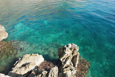 High angle view of rocks in sea