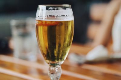 Close-up of beer glass on table