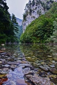 Scenic view of river with mountains in background