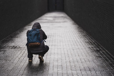 Rear view of woman walking on footpath