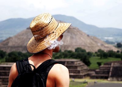 Rear view of woman looking at camera