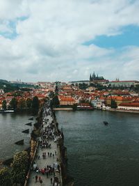 River by cityscape against sky