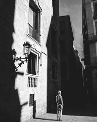 Man standing by buildings