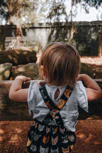 Rear view of girl standing outdoors