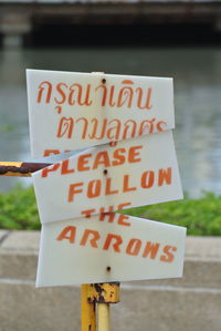 Damaged sign board by lake