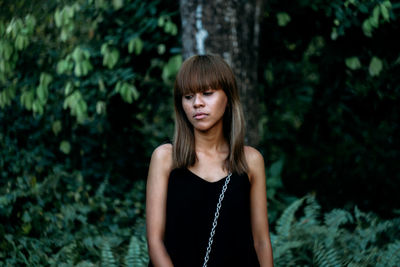 Woman standing in forest