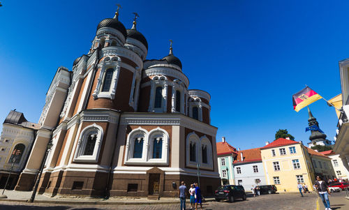 Low angle view of buildings against clear blue sky