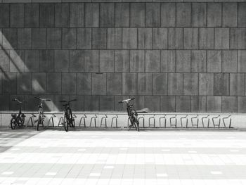 People riding bicycle on wall