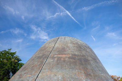 Low angle view of rusty metal against blue sky