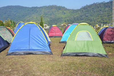 Tent on field against mountain