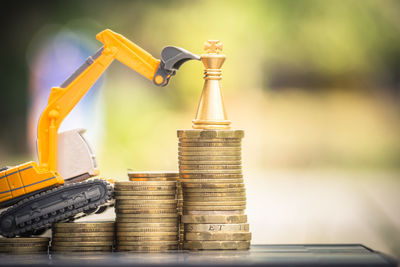 Close-up of toy with stacked coins on table