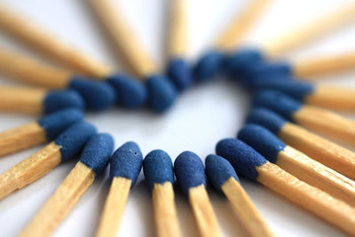 Close-up of matchsticks arranged in heart shape on table