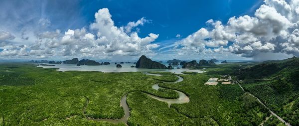 Scenic view of sea and mountains against sky