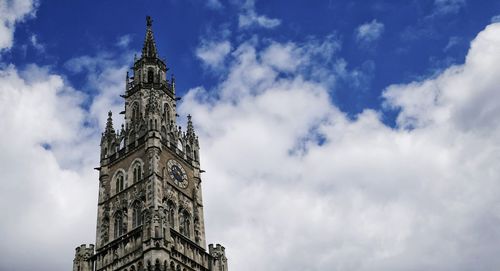 Low angle view of clock tower against cloudy sky