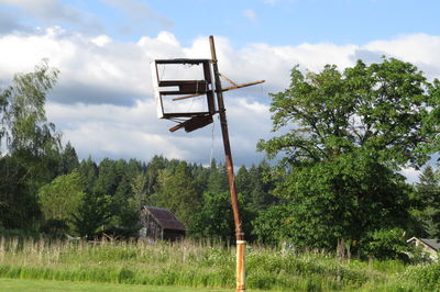 Lifeguard hut on field against sky