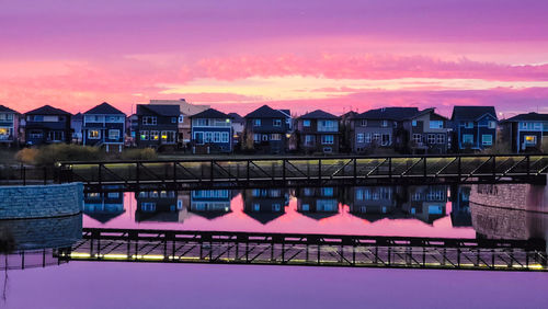 Bridge over river against sky during sunset