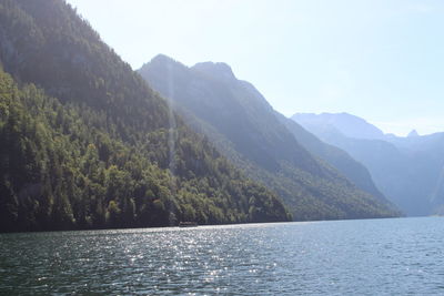 Scenic view of lake by mountains against sky