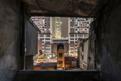 Illuminated buildings seen through window