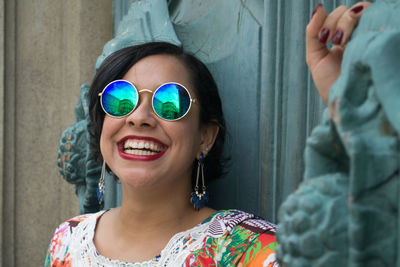 Portrait of smiling young woman wearing sunglasses