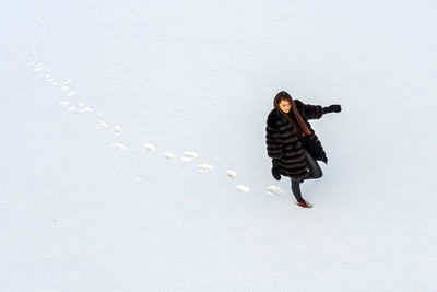 Full length of woman walking on snow