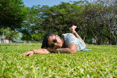 Portrait of woman lying on grass