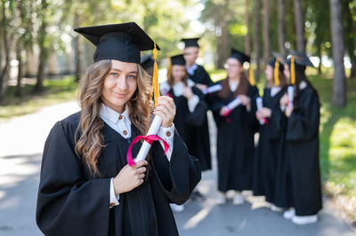 Portrait of woman wearing graduation gown