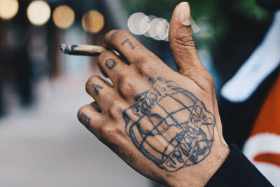 Close-up of man painting on hand