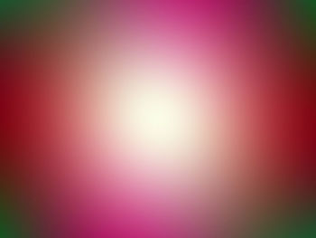 Defocused image of pink bright sun