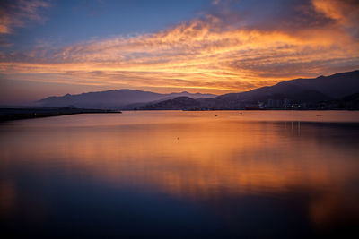 Scenic view of lake against sky during sunset