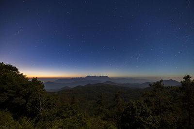 Scenic view of landscape against sky at night