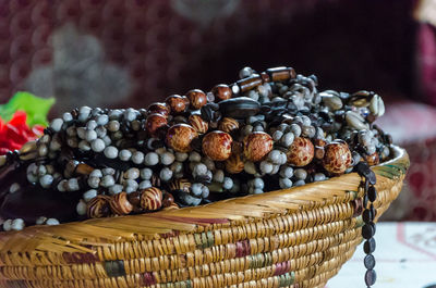 Close-up of traditional jewelry in basket, cameroon, africa