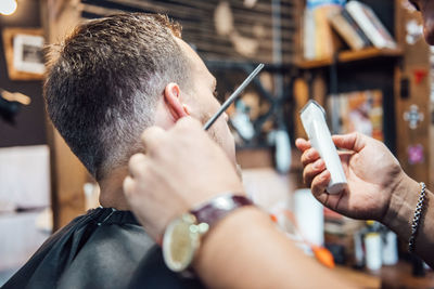 Midsection of man using mobile phone