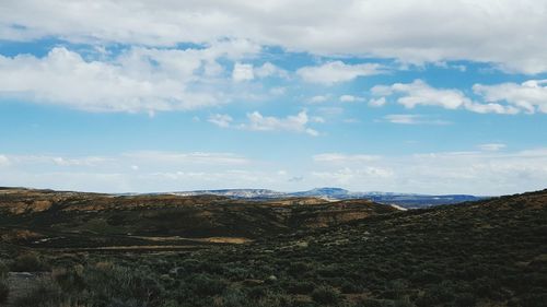 Scenic view of landscape against cloudy sky