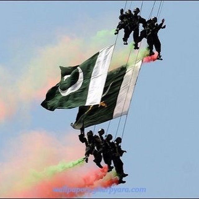 low angle view, sky, architecture, built structure, flag, art and craft, building exterior, art, creativity, cloud - sky, identity, hanging, national flag, human representation, sculpture, patriotism, day, outdoors, no people