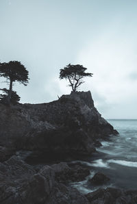 Rock formation on sea against sky