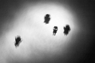 High angle view of people standing in sea