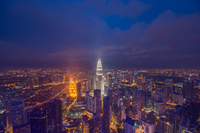 Aerial view of city lit up at night