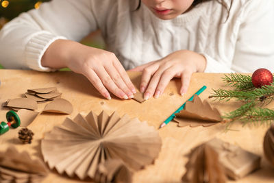 Midsection of girl drawing on table