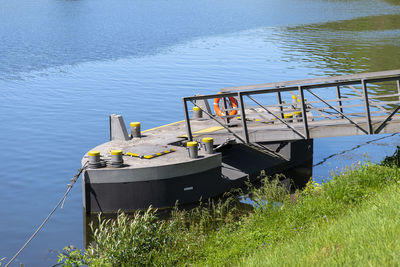 A metal platform protruding from the river bank on air tanks, a pier to the entrance to the ship.