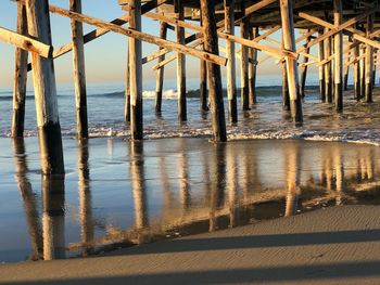 Wooden pier on sea against sky