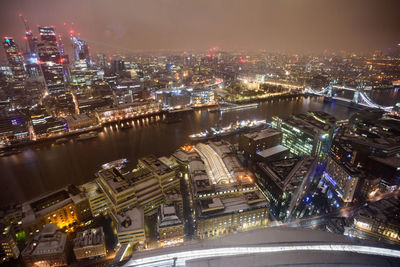 High angle view of city lit up at night