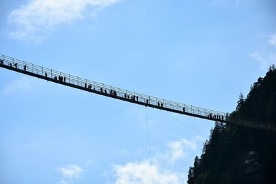 Low angle view of power lines against blue sky