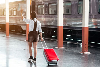 Rear view of man standing in train