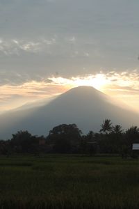 Scenic view of field against sky during sunset