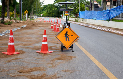 Under construction sign on the asphalt road